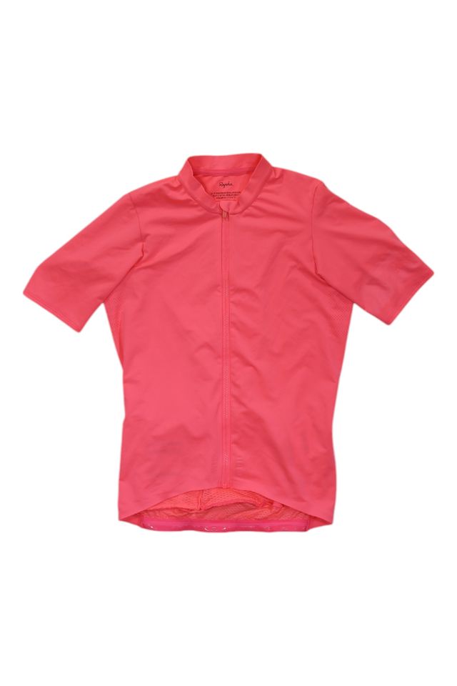 A Mens Pro Team Midweight Short Sleeve Jersey in bright pink, with a full front zipper and extended back hem, is laid flat on a white background.