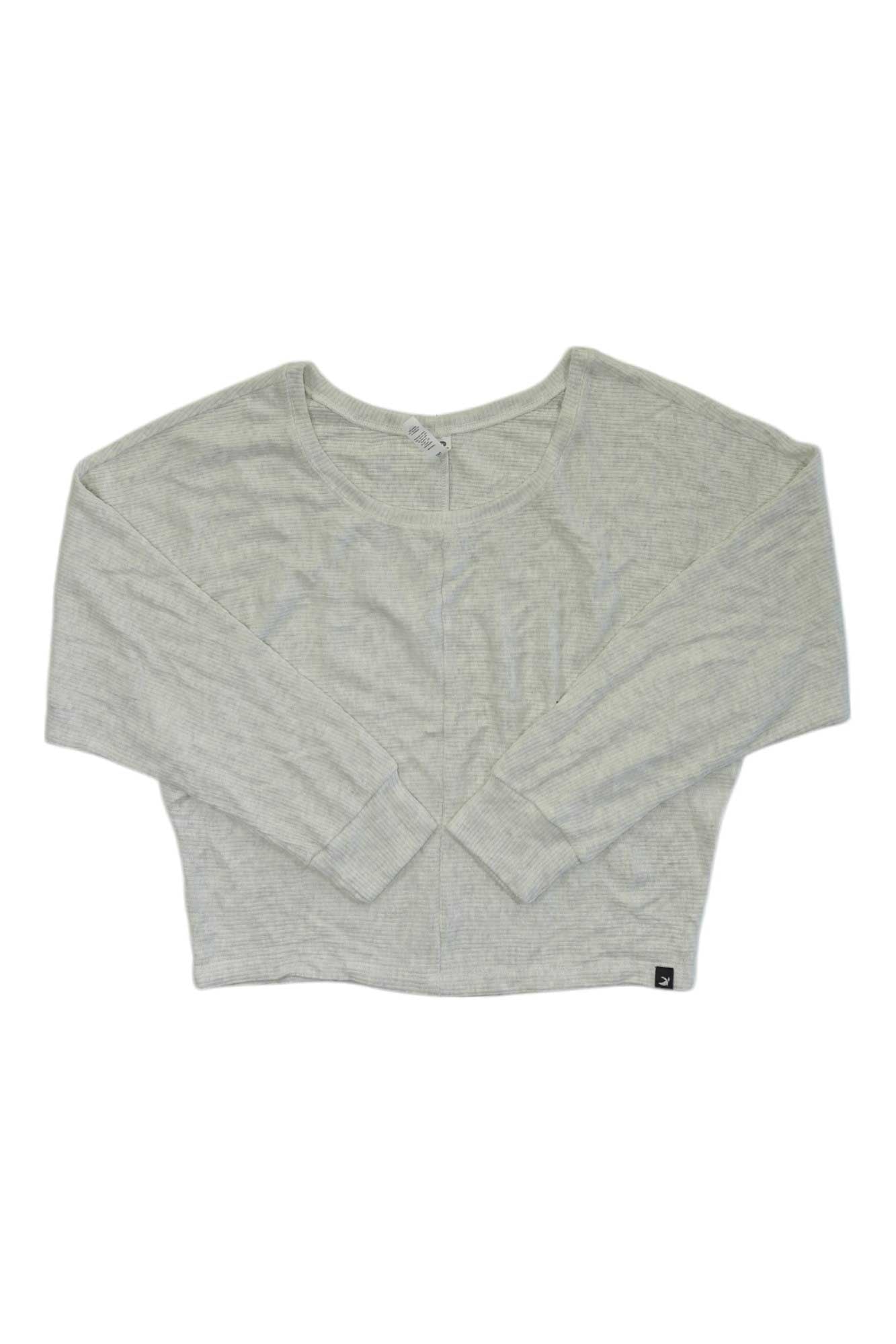 The Glyder Women's Comfort Dolman, a light gray crewneck crop top with long dolman sleeves and a relaxed fit, is laid flat on a white background. It features a small black tag at the bottom hem.