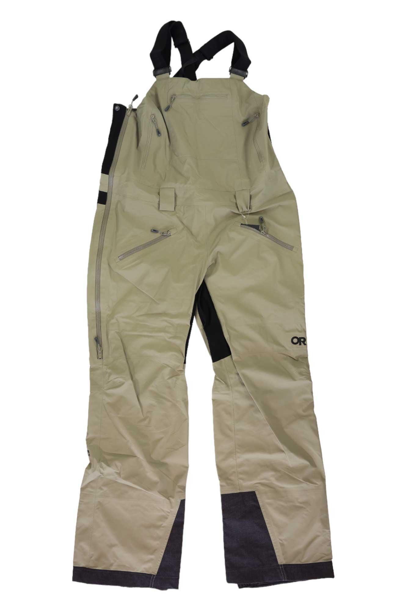 The Outdoor Research Women's Hemispheres II Bib Pant features light tan GORE-TEX waterproof fabric, multiple zippered pockets, adjustable black straps, reinforced dark cuffs and inner legs, plus an OR logo on the right thigh—perfect for skiing.