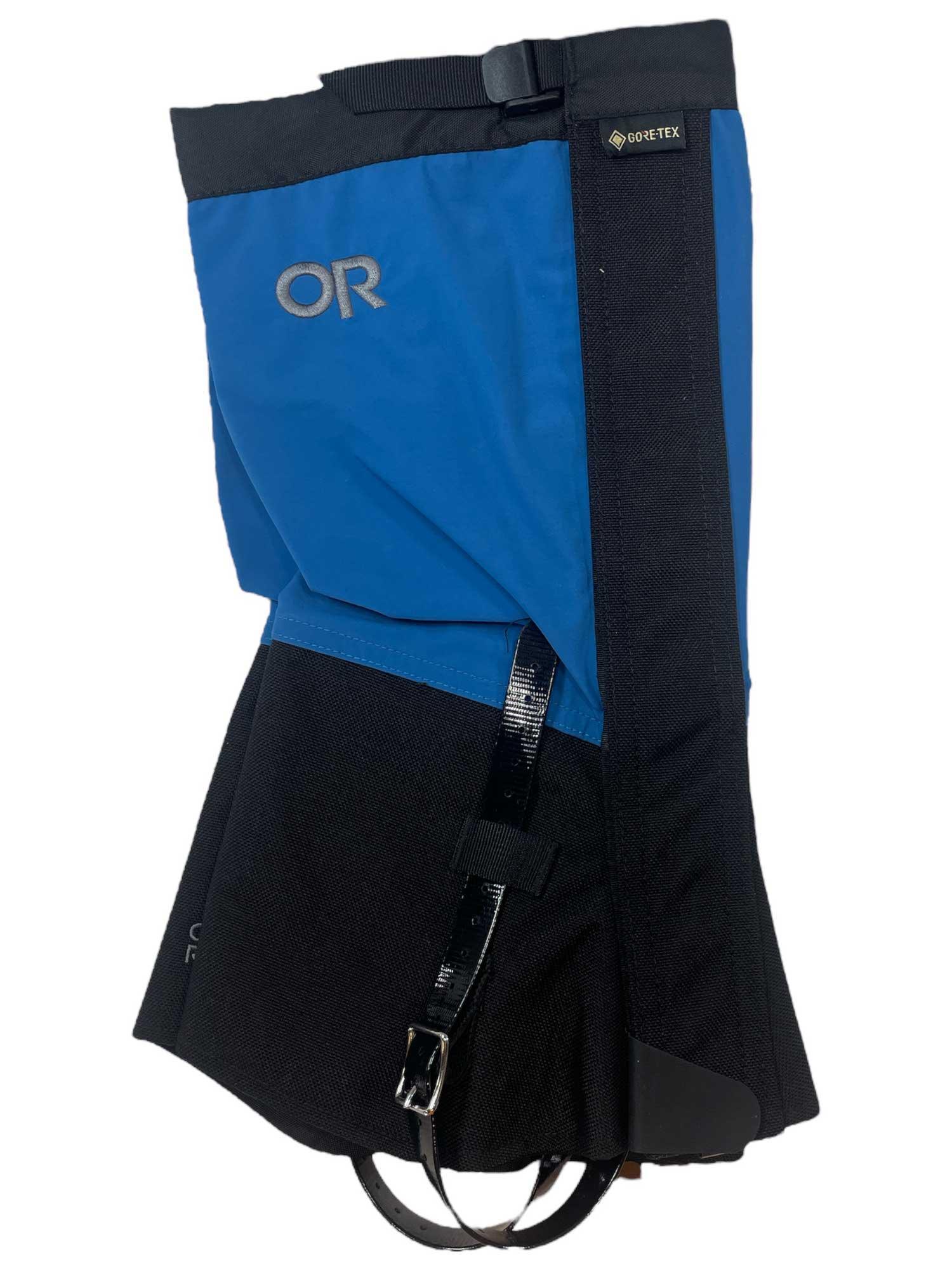 The Outdoor Research Crocodiles are blue and black waterproof gaiters with the OR logo, built from abrasion-resistant fabric, featuring a buckle strap, hook, and reinforced lower section to protect your lower leg and boot.