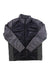 The Spyder Mens Glissade Jacket in black and gray features long sleeves, a stand-up collar, subtle embroidered logo, and a shiny quilted front. Made from recycled polyester with PrimaLoft Black Eco insulation for warmth.