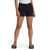 A person wears a white t-shirt, The North Face Girls' Camp Fleece 3 Inch Shorts in black with a small white logo on the left leg, and black slide sandals, standing against a plain white background.