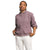 A person wears The North Face Women's Chabot Hoodie in a relaxed fit with rolled-up sleeves and white pants, standing confidently with hands in pockets against a plain white background.