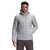 A man in The North Face Mens ThermoBall Eco Hoodie—a light gray puffer jacket with a zip-up front and chest logo—stands facing forward, one hand in his pocket.