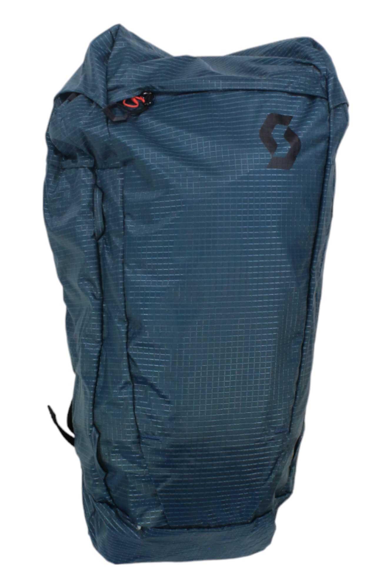 The Scott USA Mountain 35 Pack is a blue, rectangular backpack with a checkered pattern and black logo on the upper right. It features a front zipper and a ski carry system, perfect for alpine adventures.