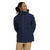 A person in a navy The North Face Men's Thermoball Eco Triclimate Jacket and khaki pants stands with hands behind their back, smiling and looking to the side against a plain white background.
