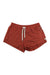 The Vuori Womens Halo Performance Short features a reddish-brown color, elastic waistband with white drawstring, side tag, and is made from moisture-wicking recycled materials for all-day comfort.