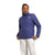 A person models The North Face Womens Shady Glade Insulated Jacket in blue with a high collar and white pants, standing facing forward against a plain white background.