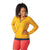 A woman with curly hair wears the Smartwool Women's Active Ultralite Hoodie Jacket over a navy top and coral shorts, standing with hands on hips, smiling and looking down against a plain white background.
