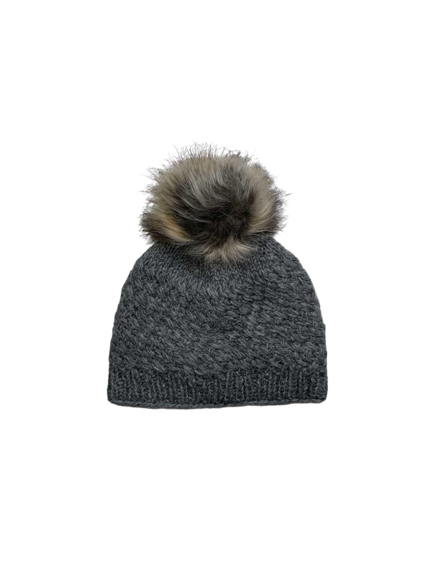 The Lost Horizons Womens Palermo Fleece Lined Beanie is a dark grey, fleece-lined women's hat featuring a large faux fur pom-pom on top, shown against a plain white background.