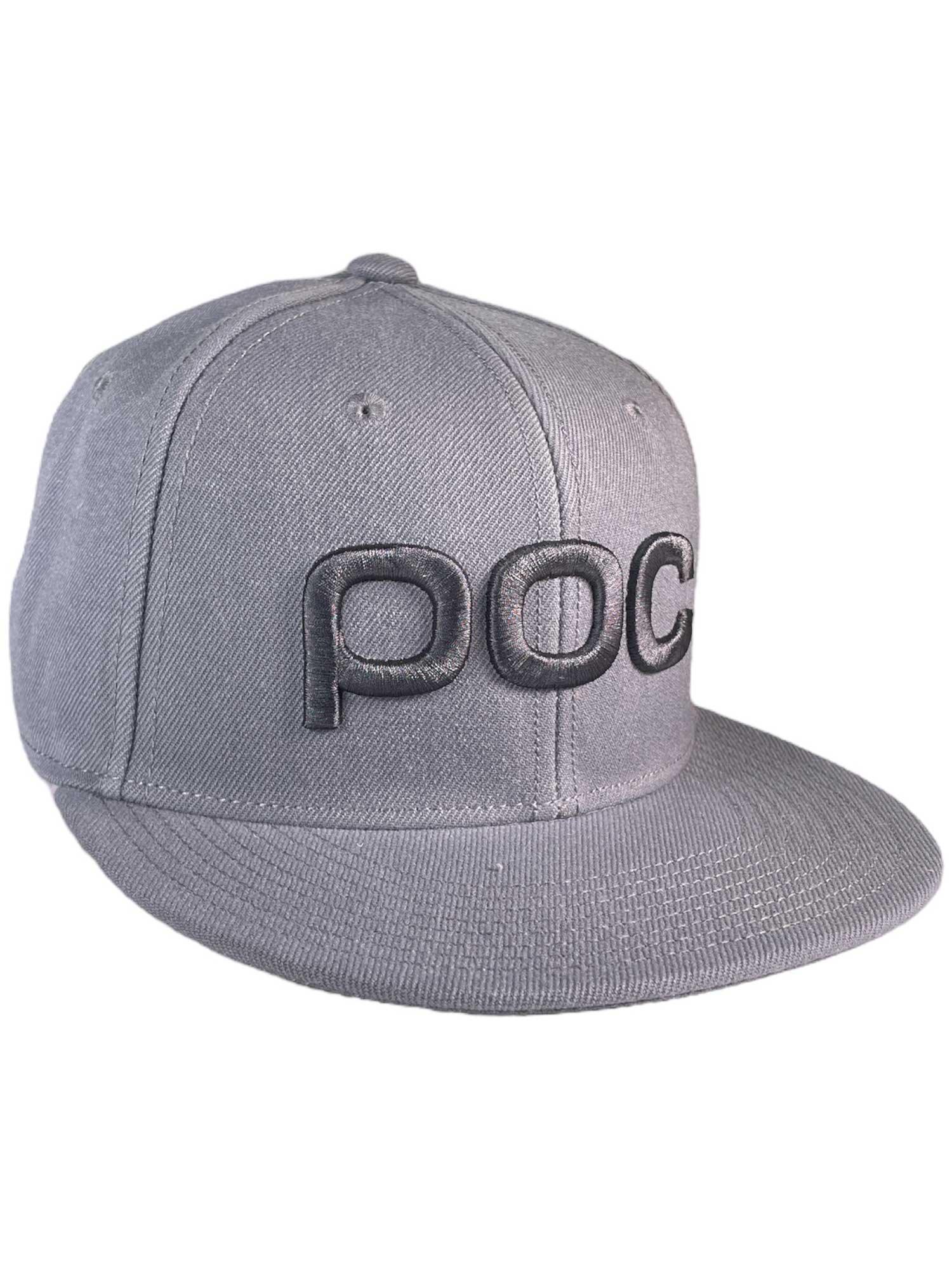 The POC Sports Juniors Corp Cap is gray with an adjustable snapback, flat brim, and features a bold black embroidered "POC" logo on the front.