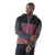 A man in a Smartwool Men's Hudson Trail Fleece Jacket, featuring maroon and dark gray panels, stands against a white background with one arm across his body, looking to the side.
