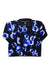 The Under Armour Women's Printed Turbofleece 1/4 Zip Top is a soft microfleece pullover with long sleeves, a collar, and a blue and white abstract tie-dye pattern on a black background.