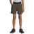 A person is wearing The North Face Boys' On The Trail Short in olive green (logo visible on left leg), a light gray t-shirt, and black athletic shoes. Shorts are made with recycled polyester. Hands are in pockets. Cropped from shoulders down.