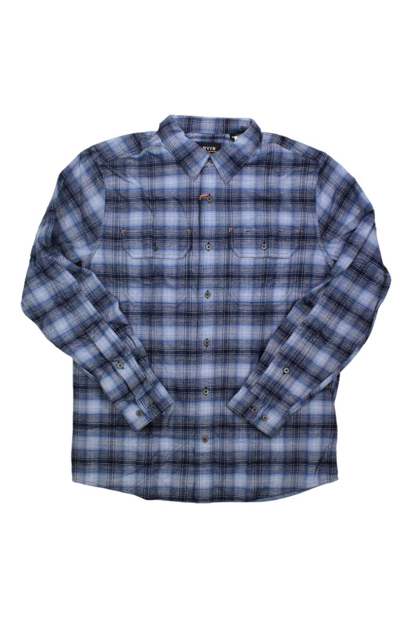 The Orvis Men's Flat Creek Tech Flannel LS Shirt is an active fit, long-sleeve flannel in blue, black, and white plaid with two button-flap chest pockets. Shirt shown laid flat on a white background.