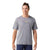 A man with long hair in a bun smiles while wearing the Smartwool Men's Active Ultralite Graphic SS Tee in light gray, featuring colorful "GO FAR FEEL GOOD" text. He stands looking slightly to the side.