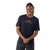 A smiling person wears the Smartwool Men's Active Ultralite Graphic SS Tee, featuring "GO FAR FEEL GOOD" in colorful letters, standing against a plain white background.
