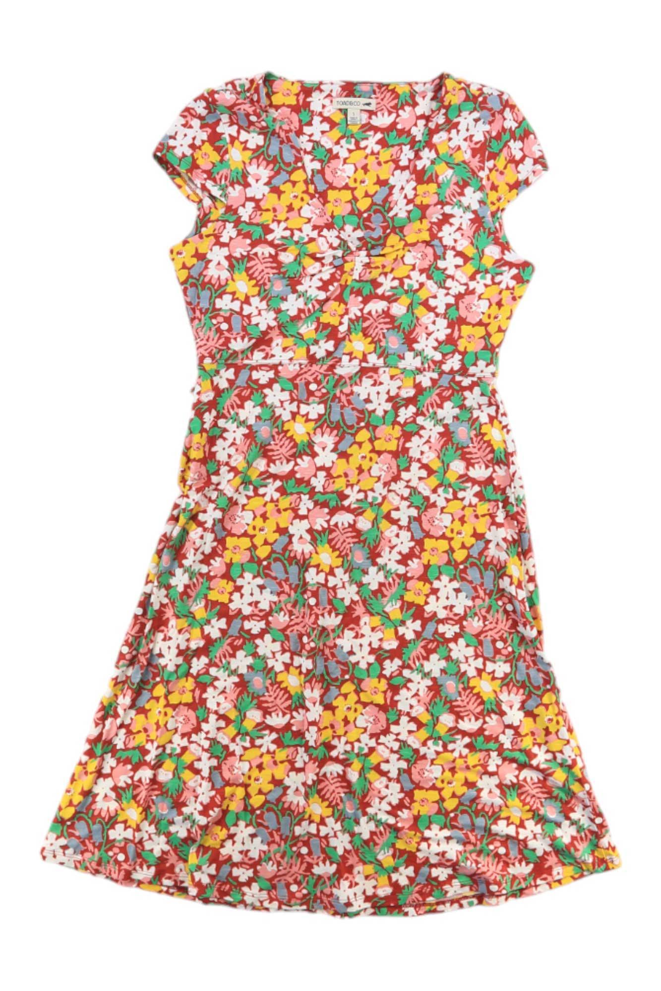 The Toad & Co Women's Rosemarie Dress is a knee-length, short-sleeve organic cotton dress featuring a colorful floral print, V-neckline, and fitted waist—a flattering, eco-friendly choice for any occasion.