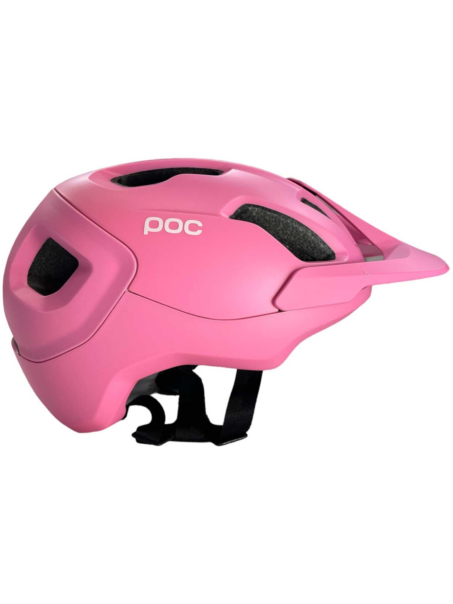 The POC Sports Axion Helmet is pink with black padding, an adjustable chin strap, multiple vents, extended protection, a small front visor, and the white POC logo on the side.