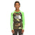 Smiling boy wearing The North Face Boys' Printed Amphibious LS Sun Tee—long-sleeve camouflage and neon green moisture-wicking shirt—stands against a white background.