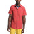 A man wears The North Face Men's Baytrail Jacq SS Shirt—short-sleeve, red, with a subtle pattern—over a blue and white striped tee and yellow pants, shown waist up against a plain background.