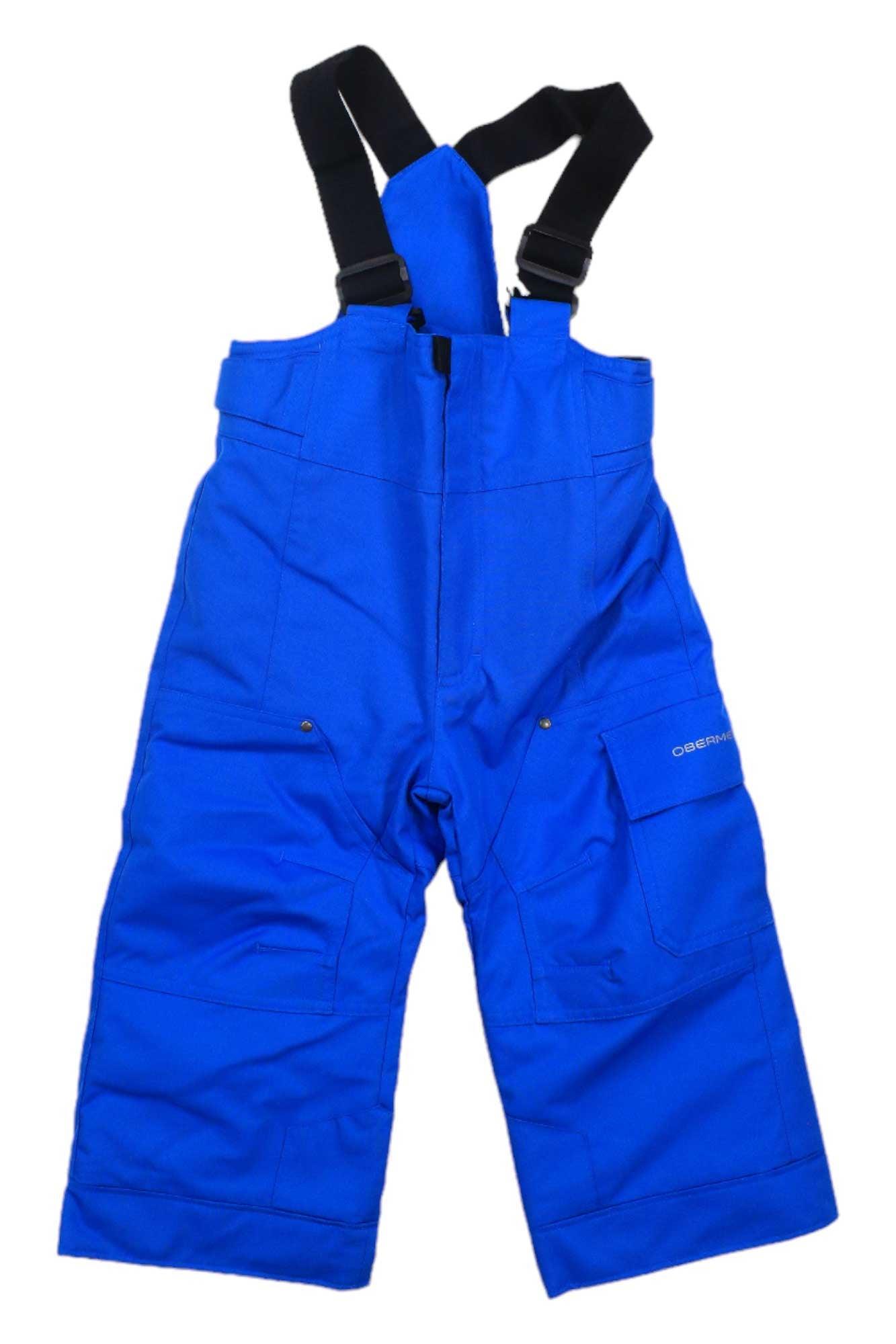 The Obermeyer Boys Volt Pant features bright blue waterproof, insulated fabric, adjustable black suspenders, and multiple pockets—ideal for winter activities. Pants are shown laid flat on a white background.