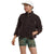 Wearing The North Face Womens Extreme Pile Pullover, a white cap, and green camo shorts, a person stands with one hand in their pocket and looks to the side against a plain background.