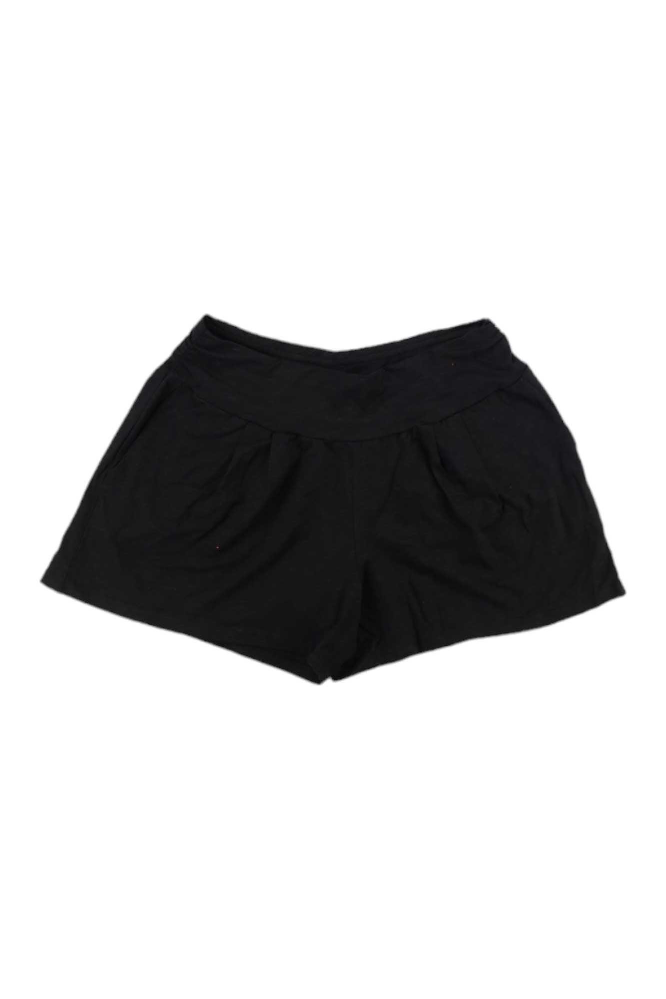 A pair of Toad & Co Women's Chaka 4 Inch Shorts in black, featuring a wide waistband and moisture-wicking fabric, is displayed flat on a white background.