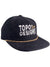 The Topo Designs Corduroy Trucker Hat - Sunrise features black corduroy, TOPO DESIGNS embroidered in white on the front with a yellow paddle above, plus a yellow accent rope on the brim for classic style and comfort.