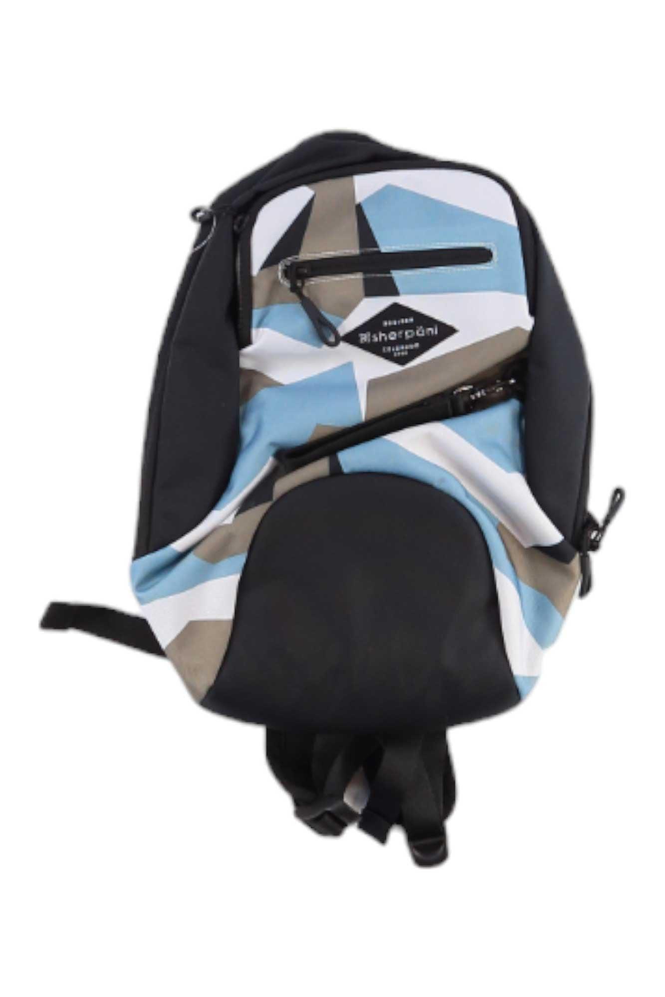 The Sherpani Women's Vespa Backpack features a geometric pattern in blue, beige, white, and black. Made from recycled materials, it includes two zippered front pockets, black straps, and a visible Sheppon brand label on the front.