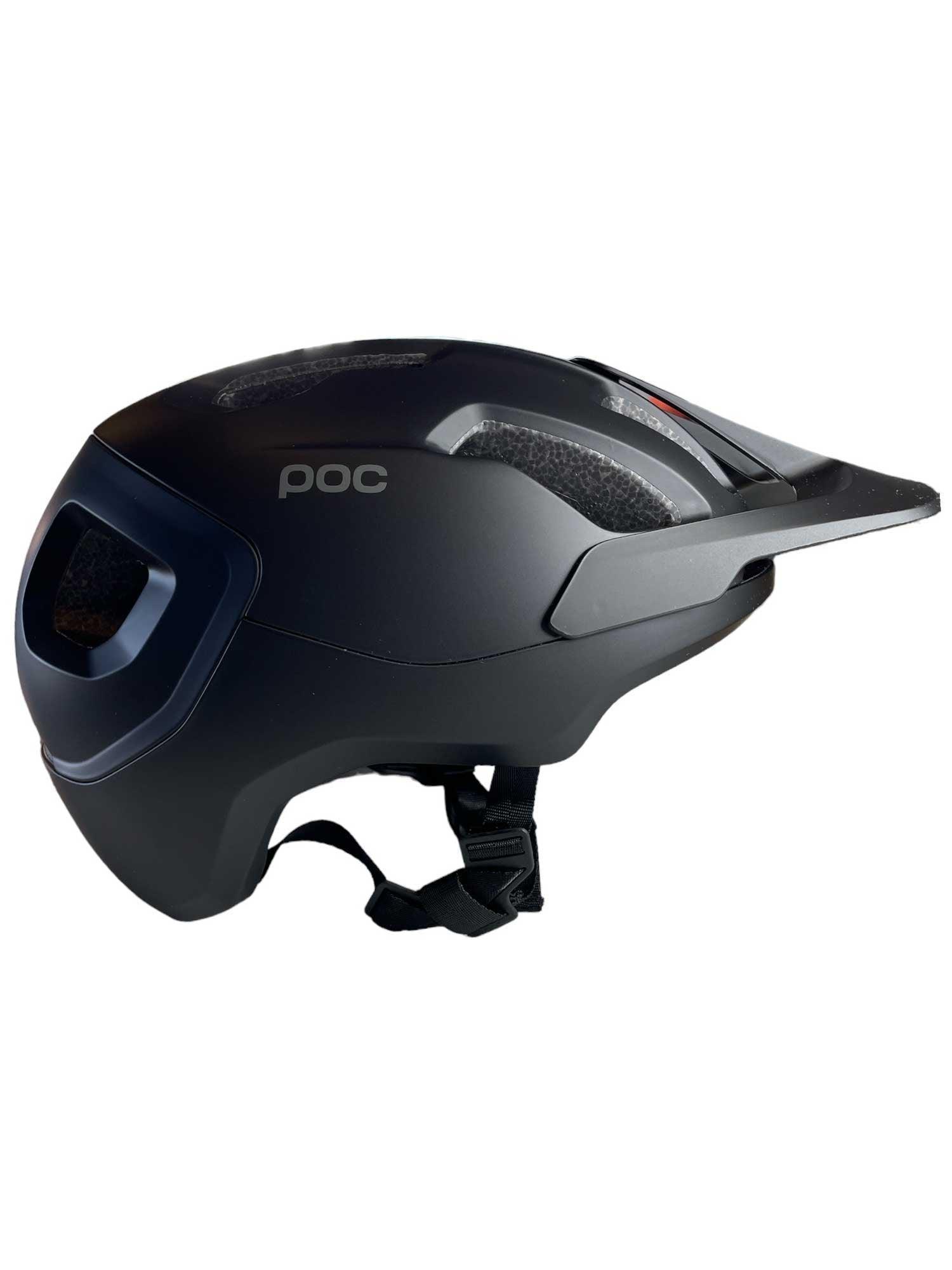 The POC Sports Axion Helmet in matte black, shown from a side profile against a white background, features a visor, side ventilation, an adjustable chin strap, and offers extended protection.