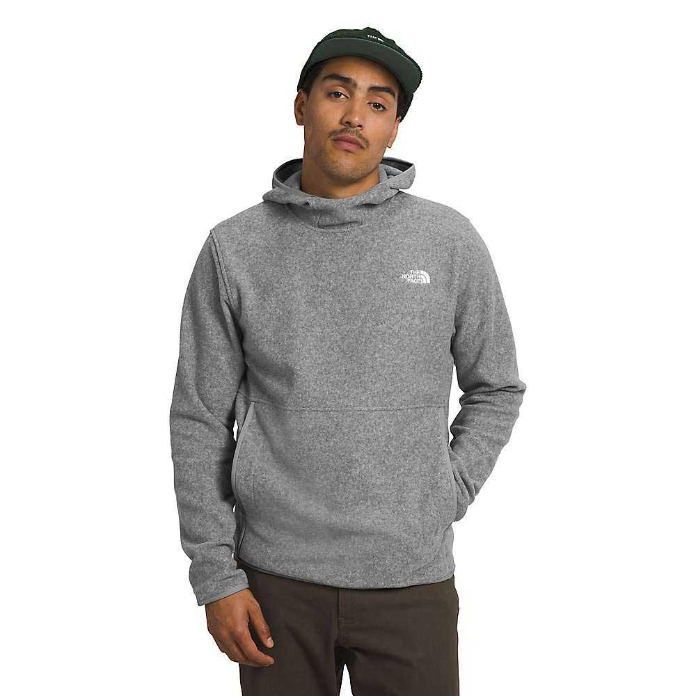 Wearing The North Face Mens Alpine Polartec 100 Pullover in gray and a dark green cap, a person stands with one hand in a pocket against a white background. The North Face logo appears on the chest.