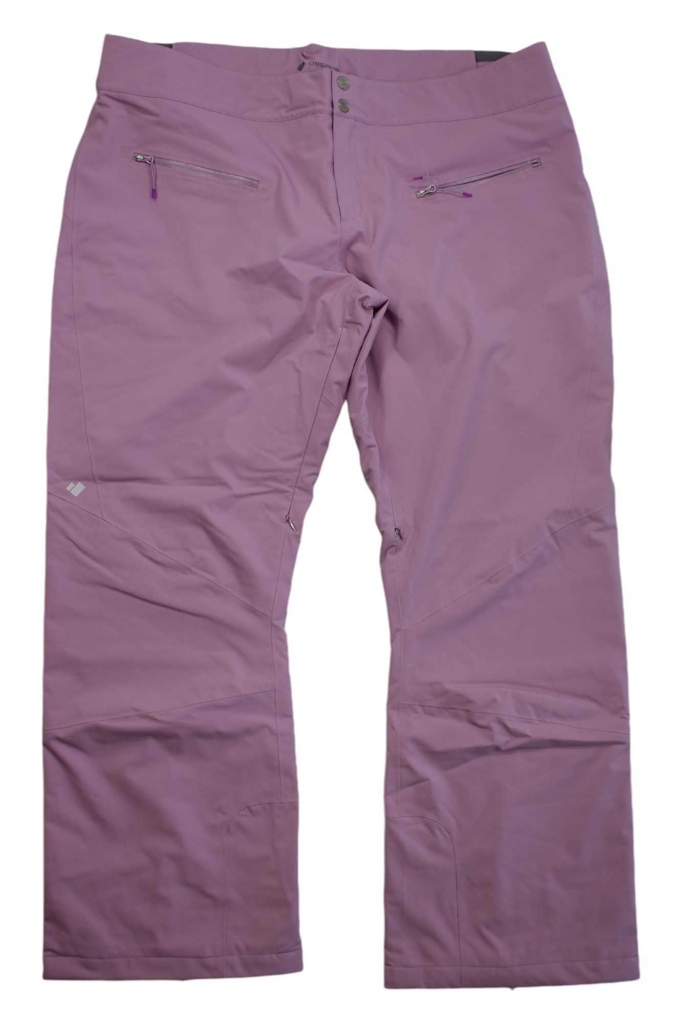 A pair of Obermeyer Womens Bliss Pant insulated ski pants in light purple, featuring zippered pockets and a button closure, laid flat on a white background.