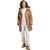 A woman with curly hair wears The North Face Womens Arctic Parka in tan over a white turtleneck, paired with white cuffed jeans and tan sneakers, standing against a plain white background.