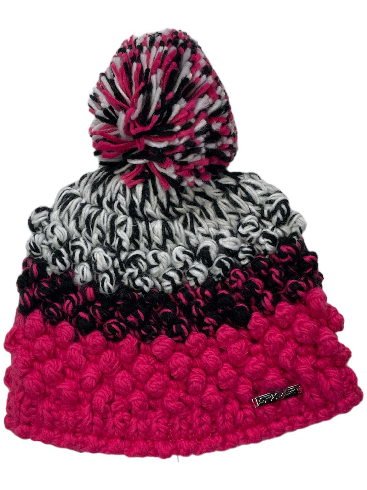The Spyder Girls Brrr Berry Hat is a cozy knitted beanie with a pom-pom, made from thick yarn and featuring black, white, gray, and bright pink stripes—perfect for keeping kids warm in winter.