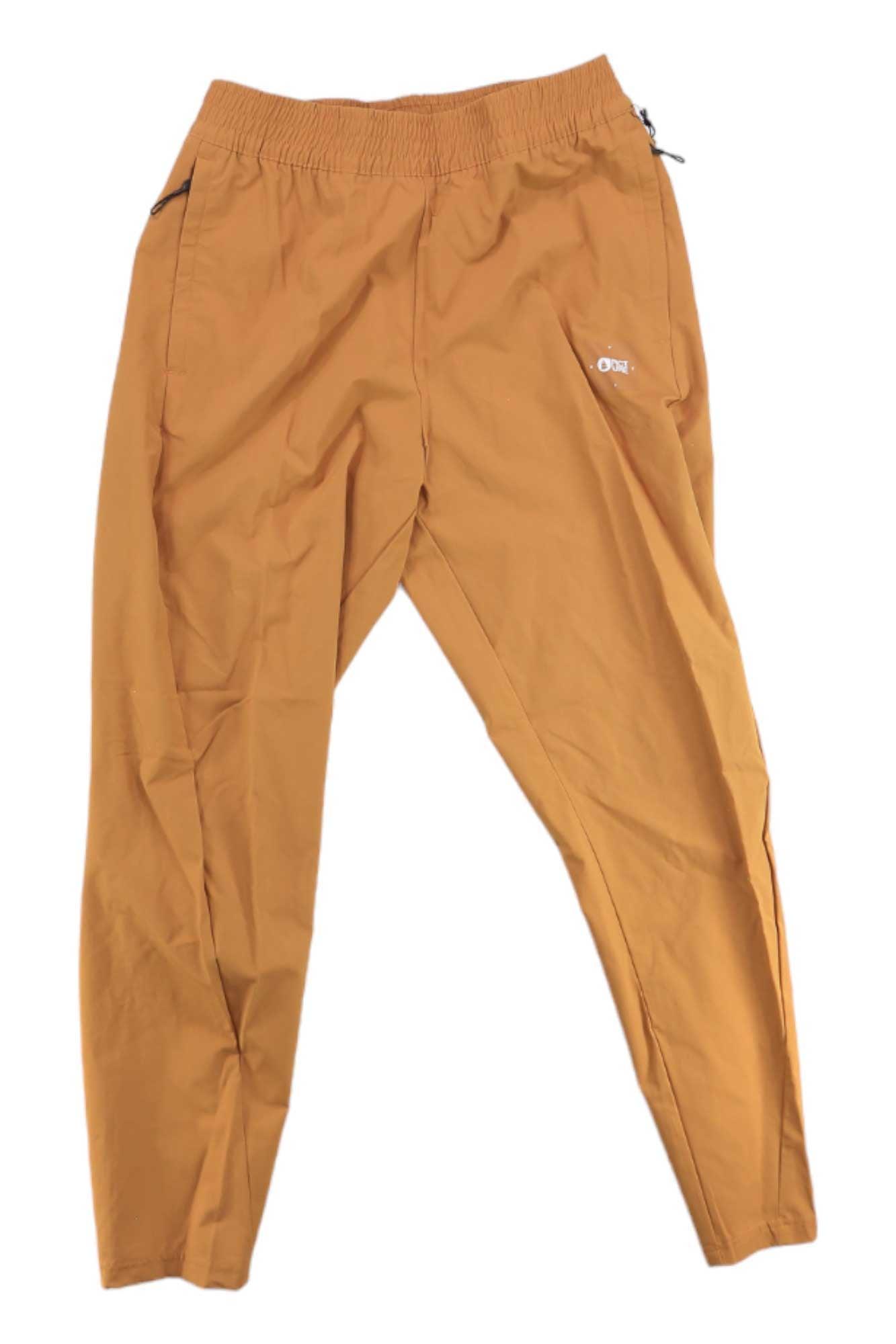 A pair of Picture Women's Tulee Stretch Pant in light brown, featuring wicking technology, an elastic waistband, and zippered pockets, laid flat on a white background.