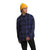 A person wearing a yellow knit beanie, The North Face Mens Campshire Shirt in blue and black plaid, and black pants stands against a plain white background, looking to the side.