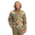 A man with blond hair wears The North Face Men's Printed Gordon Lyons 1/4 Zip Top—a camouflage fleece with a chest pocket—paired with olive-green pants, standing with one hand in his pocket.