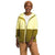 A woman smiles and stands against a plain white background, wearing a tan beanie, white t-shirt, tan pants, and The North Face Women's Mountain Sweatshirt Hoodie.