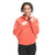 A person with curly hair wearing The North Face Women's Exploration Full Zip Hoodie in orange and black pants stands facing the camera against a plain white background.