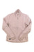 The Saucony Women's Triumph Jacket is a light pink running jacket with a high collar and long sleeves, made from smooth, lightweight, wind- and water-resistant material. The jacket is shown laid flat on a white background.