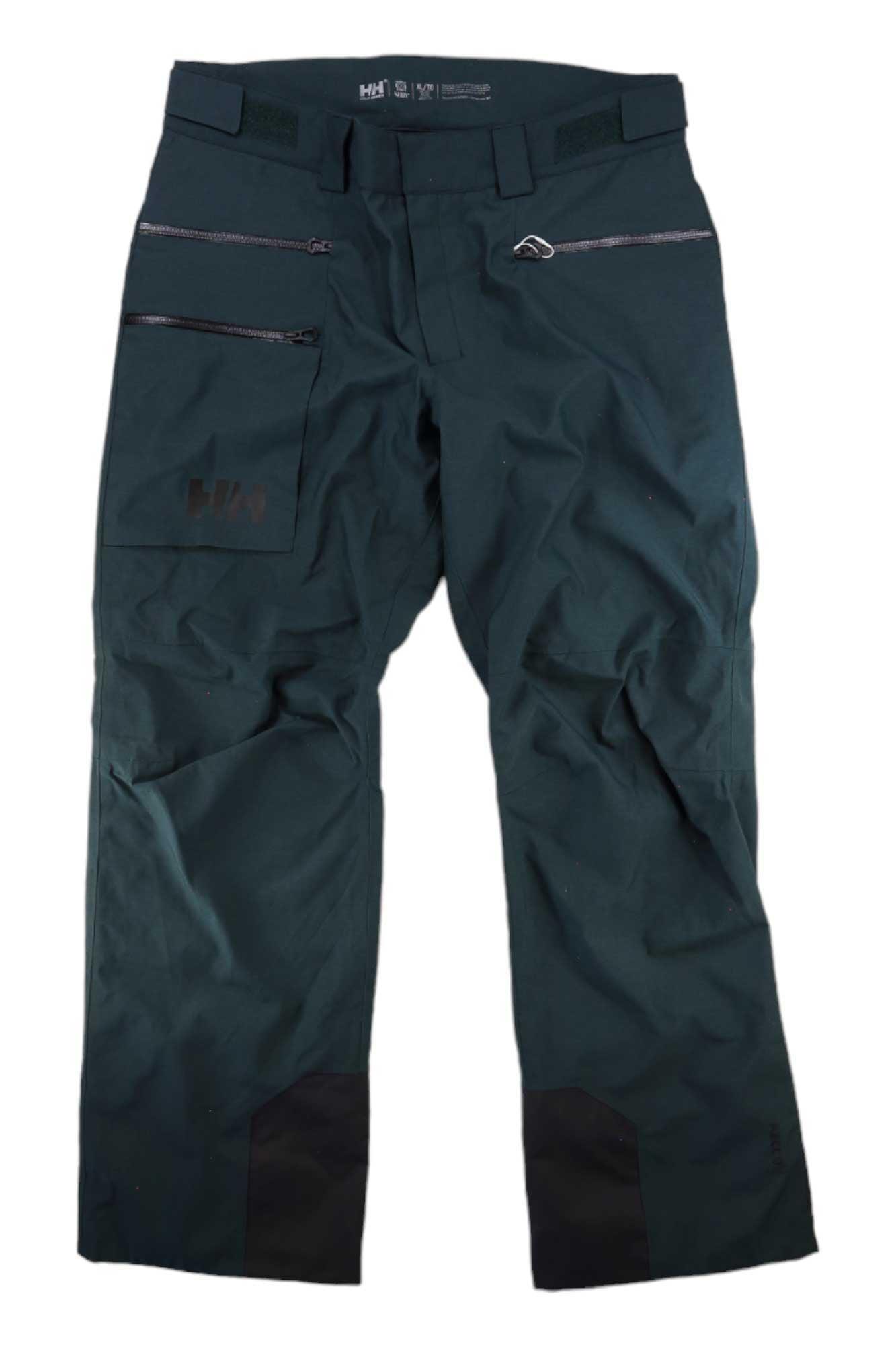A pair of Helly Hansen Mens Garibaldi 2.0 Pants in dark green with black reinforced cuffs, zipper pockets, and adjustable waist tabs displayed flat on a white background.