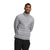 A man smiles at the camera against a plain white background, wearing The North Face Mens Belleview Stretch Down Jacket in light grey with recycled down insulation and dark pants, his arms behind his back.