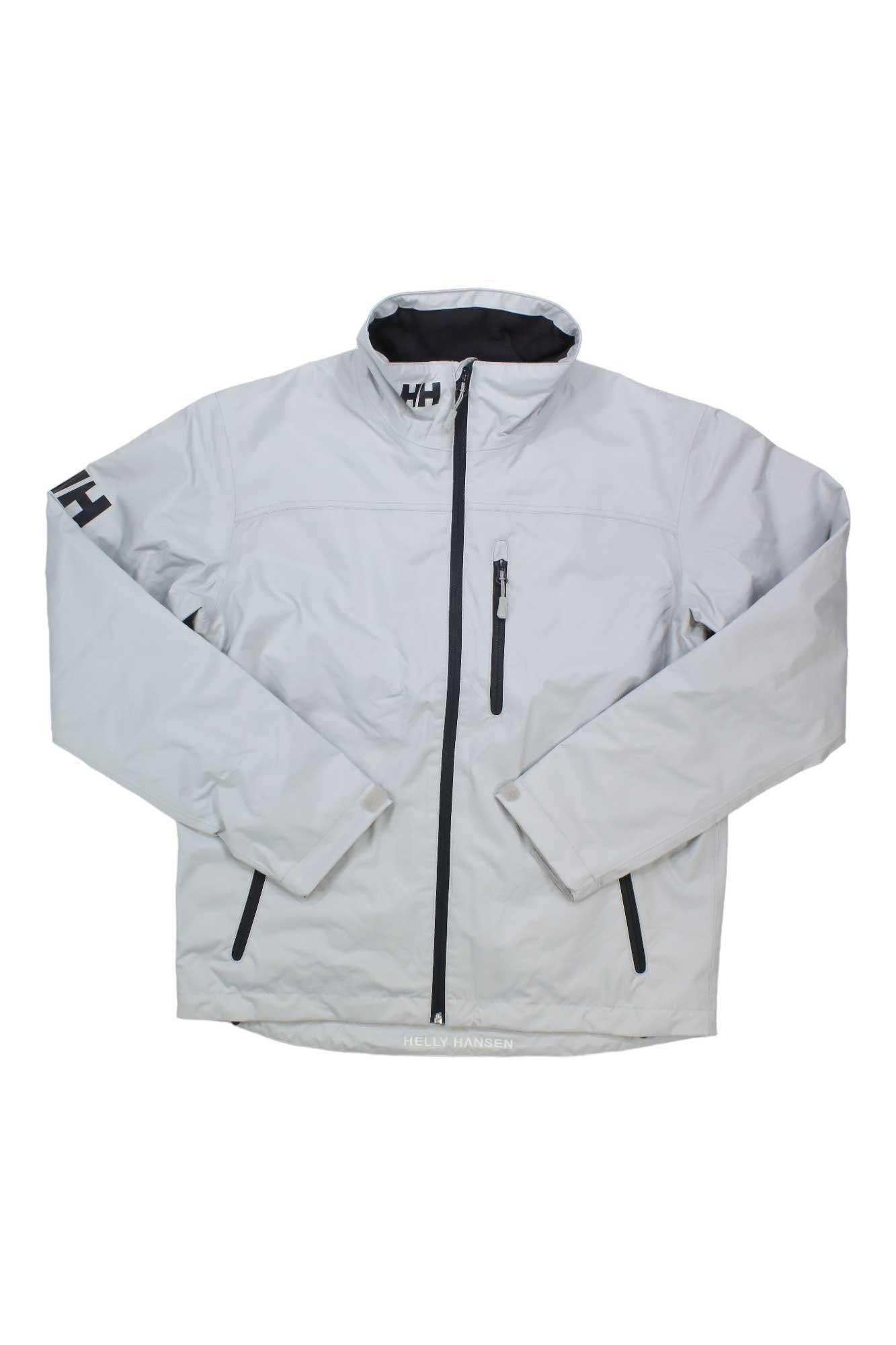 The Helly Hansen Men's Crew Midlayer Jacket is light gray, windproof, and fleece-lined with a front zipper, standing collar, long sleeves, zippered chest and side pockets, plus HH logos on the left sleeve and collar.