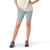 Wearing a white shirt, Smartwool Women's Active Biker Short in light blue with a high-rise waist and side pocket, and black athletic shoes with pink laces, a person stands with one hand on their hip against a white background.