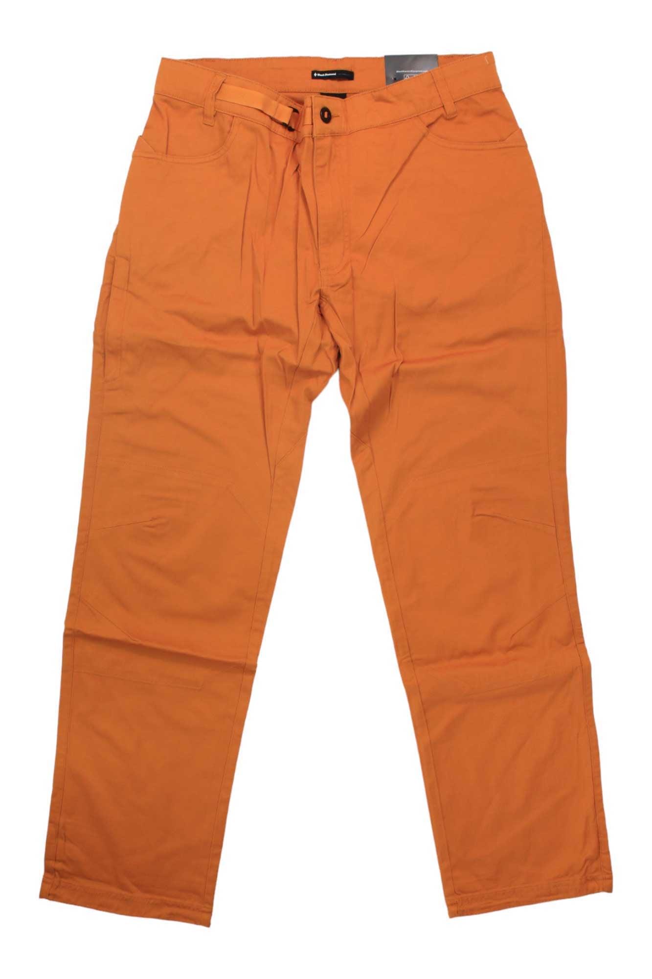 The Black Diamond Men's Credo Pant in orange, featuring front pockets, belt loops, and a button closure, is displayed flat on a white background.