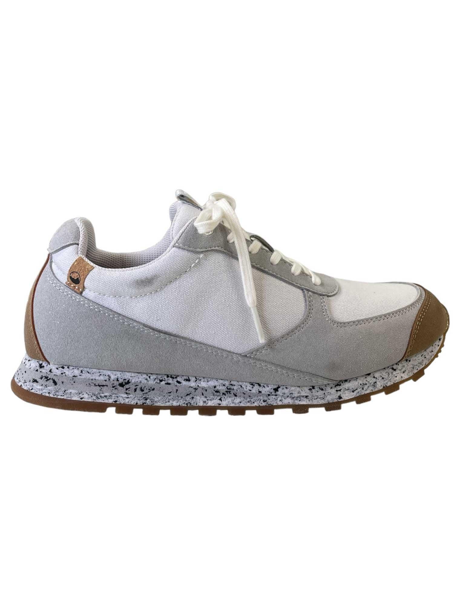 The Saola Womens Alta Vibram Shoes feature a white upper with gray and tan accents, white laces, and a speckled gray recycled-material sole, shown in side profile against a white background.