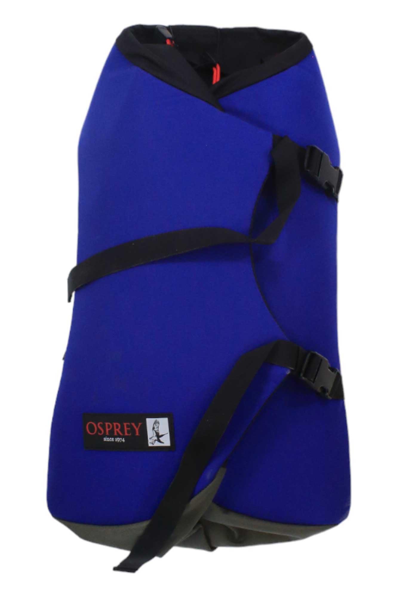 A blue dog jacket featuring black adjustable straps, buckles, and a logo patch—crafted with care like the Osprey Heritage Scarab Backpack and inspired by recycled nylon backpack designs for warmth and protection.