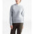 A person wears The North Face Women's Crescent Sweater in light gray—a relaxed-fit, casual crew made from recycled polyester—over a white shirt and olive green pants. The sweater features a front pocket and effortless style against a plain white background.