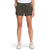 A person stands against a plain white background, showing only their lower half in The North Face Womens Aphrodite Motion 6 Inch Short in olive green, paired with a white T-shirt and light-colored sneakers.